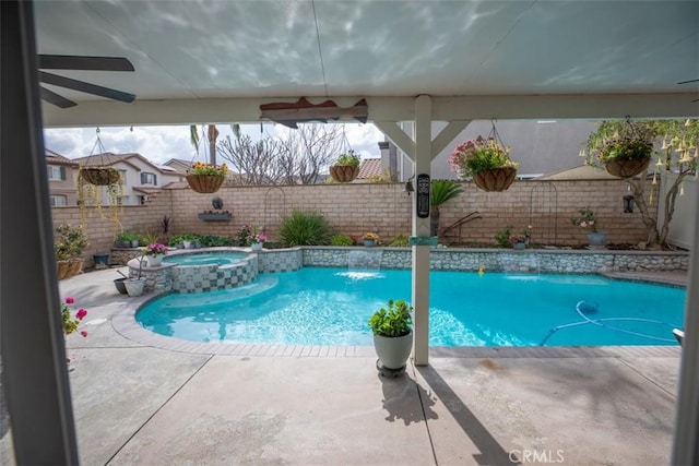 view of swimming pool with a fenced backyard, ceiling fan, and a pool with connected hot tub