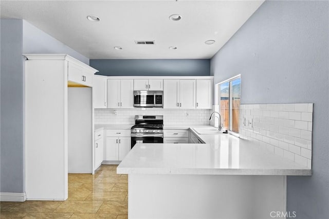 16129 Windcrest Dr, Fontana, CA 92337 - kitchen with appliances with stainless steel finishes, a sink, backsplash, light countertops, and recessed lighting