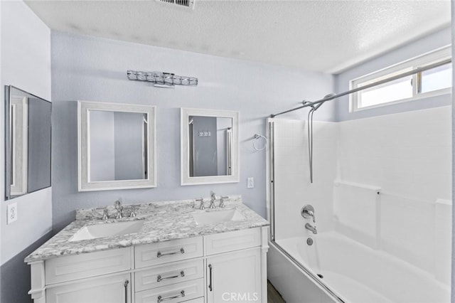 16129 Windcrest Dr, Fontana, CA 92337 - bathroom with a textured ceiling, double vanity, and bathing tub / shower combination