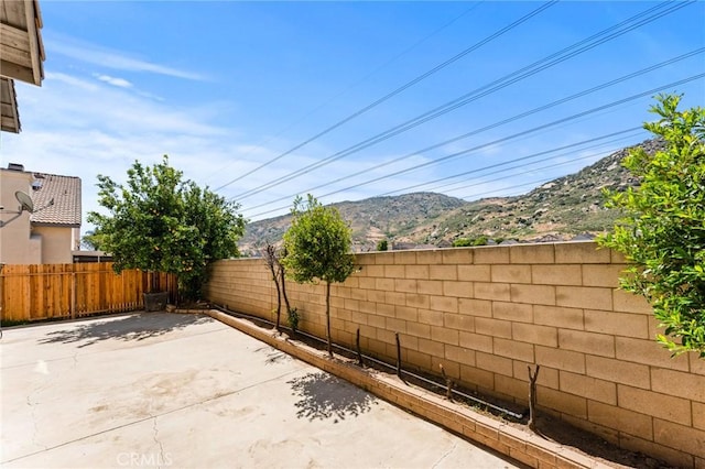 16129 Windcrest Dr, Fontana, CA 92337 - view of patio with a fenced backyard and a mountain view