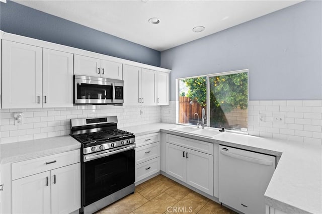 16129 Windcrest Dr, Fontana, CA 92337 - kitchen with appliances with stainless steel finishes, a sink, light countertops, backsplash, and recessed lighting