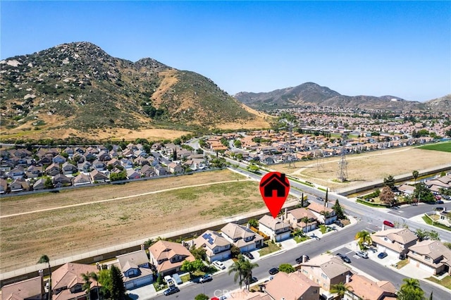 16129 Windcrest Dr, Fontana, CA 92337 - aerial overview of property's location featuring nearby suburban area and mountains
