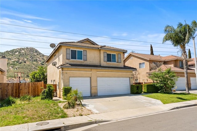 16129 Windcrest Dr, Fontana, CA 92337 - traditional-style house with concrete driveway, an attached garage, fence, stucco siding, and a tile roof
