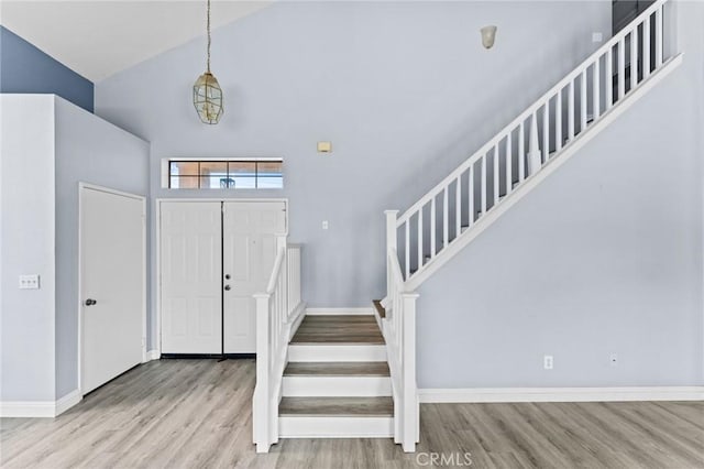 16129 Windcrest Dr, Fontana, CA 92337 - entrance foyer with wood finished floors, high vaulted ceiling, stairway, and baseboards