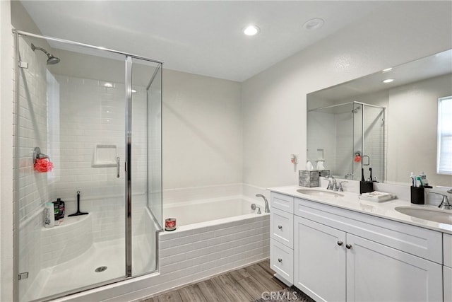 7354 Freesia Ln, Chino, CA 91708 - full bath with a shower stall, wood finished floors, a bath, double vanity, and recessed lighting