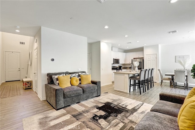 7354 Freesia Ln, Chino, CA 91708 - living room with light wood finished floors, recessed lighting, and baseboards