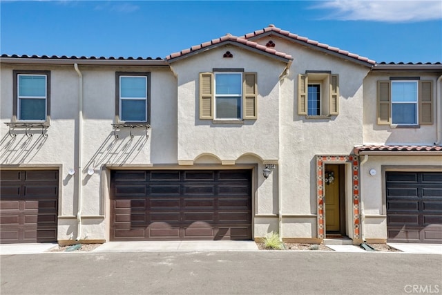7354 Freesia Ln, Chino, CA 91708 - view of property with stucco siding, a garage, and a tile roof