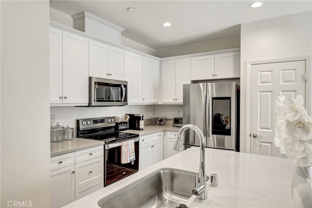 7354 Freesia Ln, Chino, CA 91708 - kitchen featuring stainless steel appliances, light countertops, white cabinets, and recessed lighting