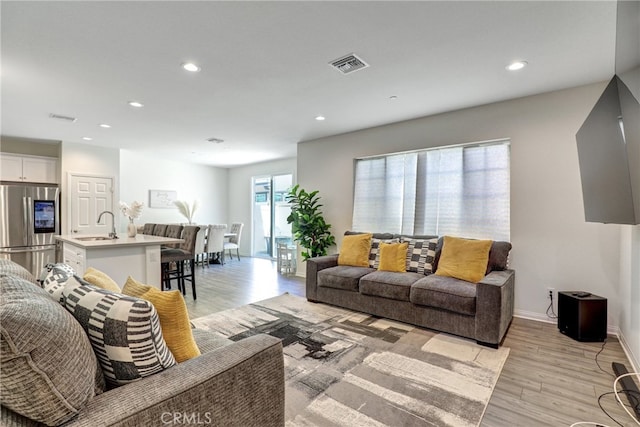 7354 Freesia Ln, Chino, CA 91708 - living area featuring light wood-style floors, recessed lighting, and baseboards