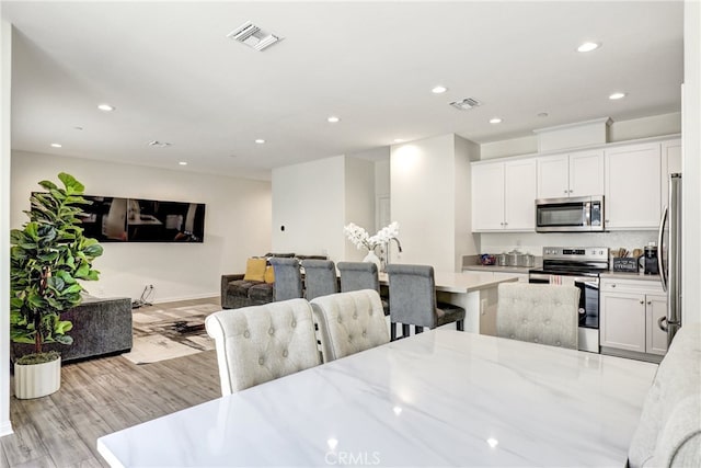 7354 Freesia Ln, Chino, CA 91708 - dining room featuring recessed lighting and light wood-style floors