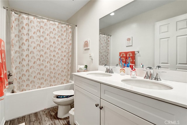 7354 Freesia Ln, Chino, CA 91708 - full bath featuring wood finished floors, toilet, shower / bath combo with shower curtain, double vanity, and recessed lighting
