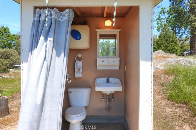5027 Fox Creek Rd, Mariposa, CA 95338 - bathroom featuring wooden ceiling, toilet, beam ceiling, and a sink
