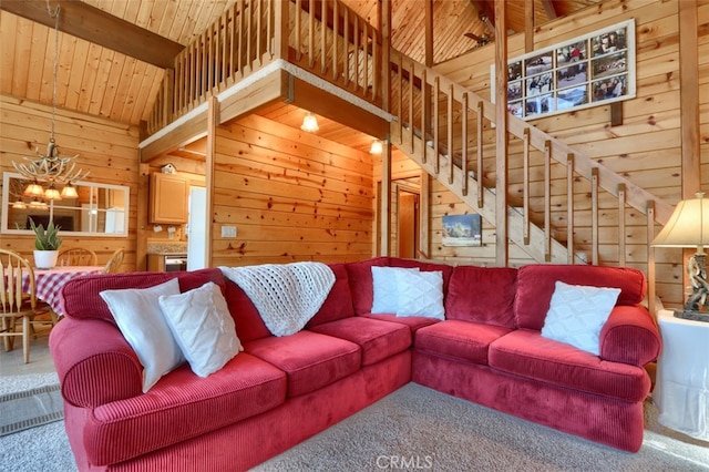 5027 Fox Creek Rd, Mariposa, CA 95338 - carpeted living room featuring wood walls, wooden ceiling, a chandelier, and stairs