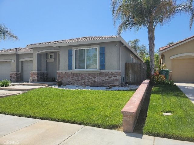 511 Milano Ct, Los Banos, CA 93635 - view of front of home featuring stucco siding, a garage, brick siding, and a tiled roof