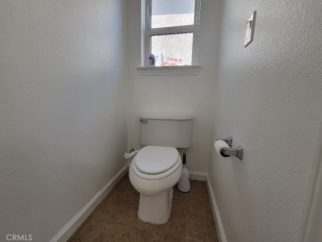 511 Milano Ct, Los Banos, CA 93635 - bathroom featuring toilet, baseboards, and tile patterned floors