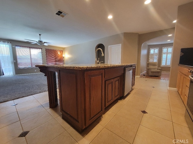 511 Milano Ct, Los Banos, CA 93635 - kitchen with stainless steel dishwasher, open floor plan, plenty of natural light, recessed lighting, and arched walkways