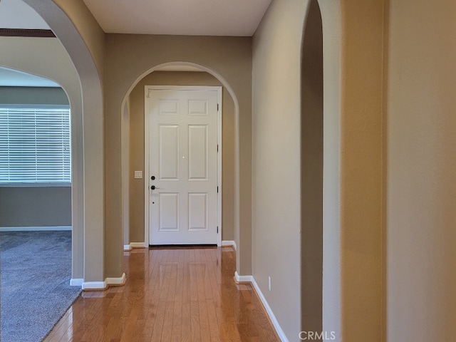 511 Milano Ct, Los Banos, CA 93635 - corridor with hardwood / wood-style floors, baseboards, and arched walkways