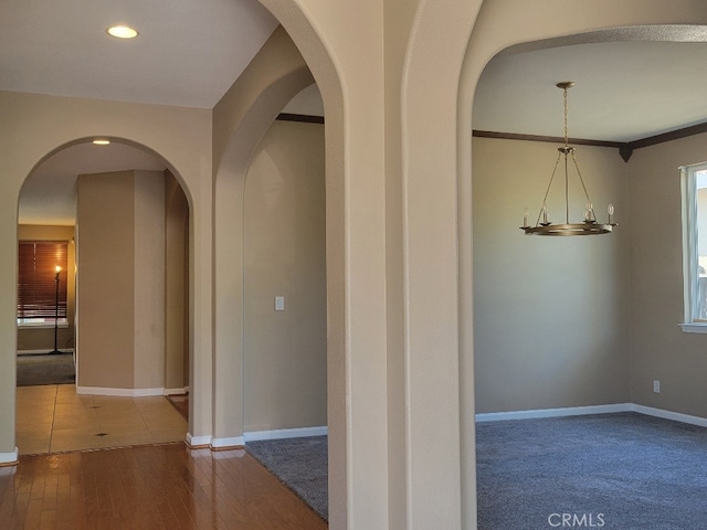 511 Milano Ct, Los Banos, CA 93635 - corridor featuring wood-type flooring, baseboards, arched walkways, and recessed lighting