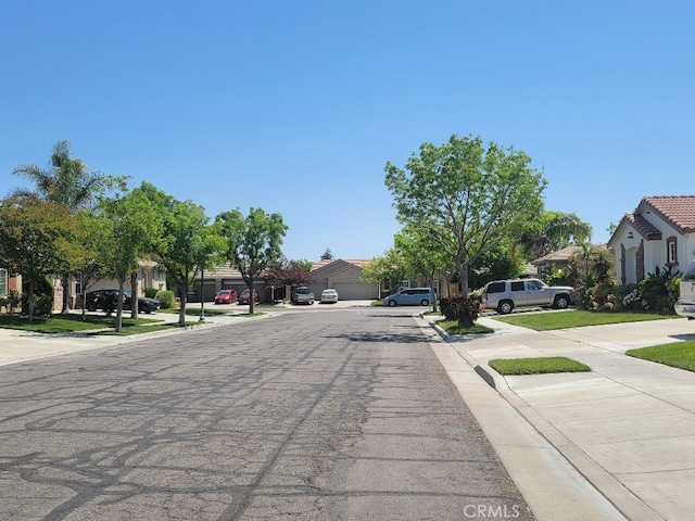511 Milano Ct, Los Banos, CA 93635 - view of asphalt street featuring a residential view, curbs, and sidewalks