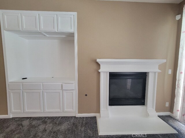 511 Milano Ct, Los Banos, CA 93635 - detailed view of baseboards, carpet, and a glass covered fireplace