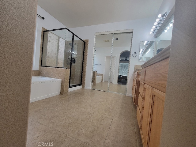 511 Milano Ct, Los Banos, CA 93635 - bathroom with a stall shower, a bath, and tile patterned flooring