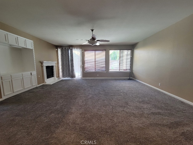 511 Milano Ct, Los Banos, CA 93635 - unfurnished living room featuring dark colored carpet, a fireplace, baseboards, and a ceiling fan