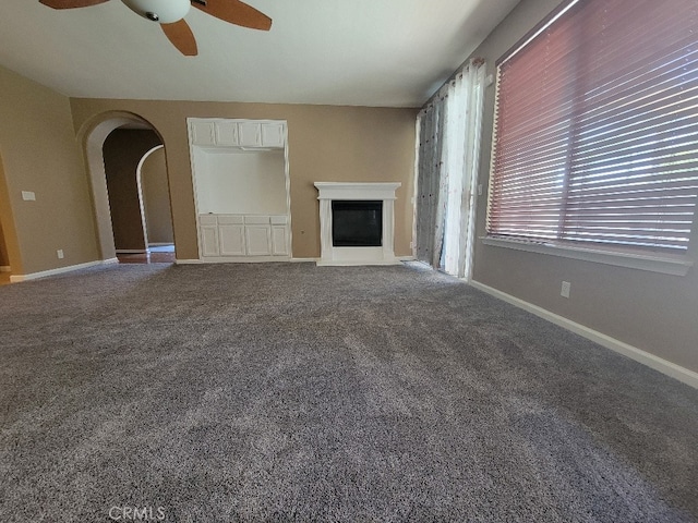 511 Milano Ct, Los Banos, CA 93635 - unfurnished living room with ceiling fan, arched walkways, baseboards, and carpet floors