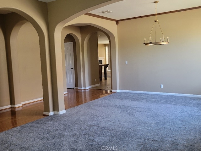 511 Milano Ct, Los Banos, CA 93635 - carpeted empty room with crown molding, baseboards, and a chandelier