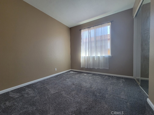511 Milano Ct, Los Banos, CA 93635 - empty room with carpet floors, baseboards, and lofted ceiling