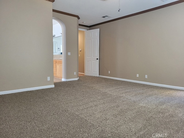 511 Milano Ct, Los Banos, CA 93635 - empty room with crown molding, arched walkways, and carpet flooring