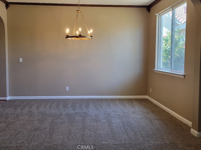 511 Milano Ct, Los Banos, CA 93635 - unfurnished room with a chandelier, arched walkways, carpet flooring, and crown molding