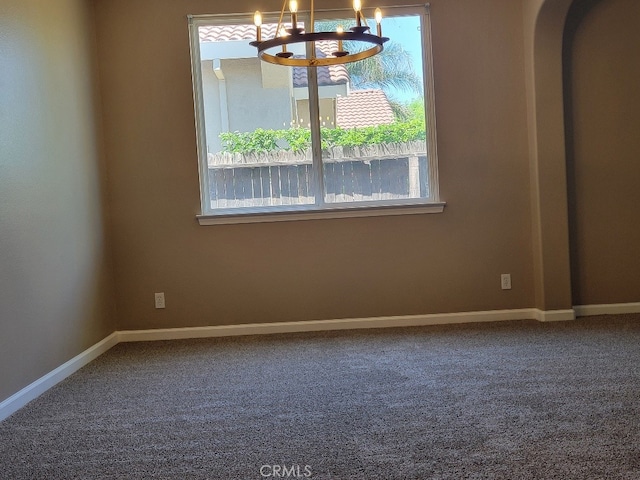 511 Milano Ct, Los Banos, CA 93635 - carpeted spare room with a chandelier and arched walkways