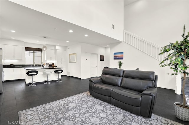 7 Abarrota St, Rancho Mission Viejo, CA 92694 - living area with recessed lighting, dark wood-style flooring, baseboards, and a towering ceiling