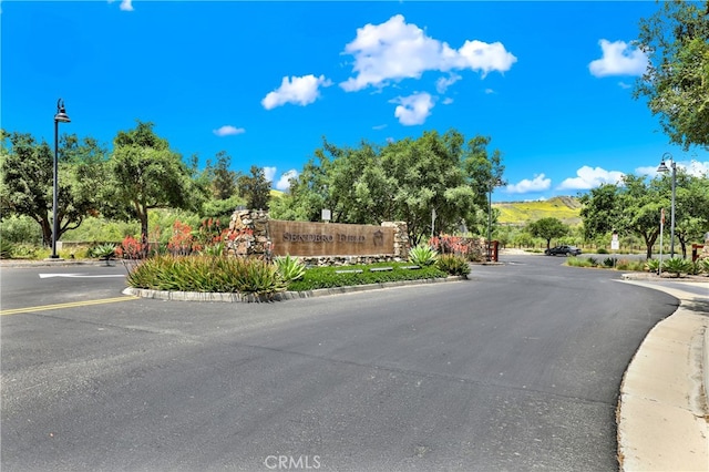 7 Abarrota St, Rancho Mission Viejo, CA 92694 - view of asphalt road featuring street lights, curbs, and a mountain view