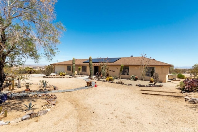6425 Indian Cove Rd Unit 29, Palms, CA 92277 - back of property with solar panels and stucco siding