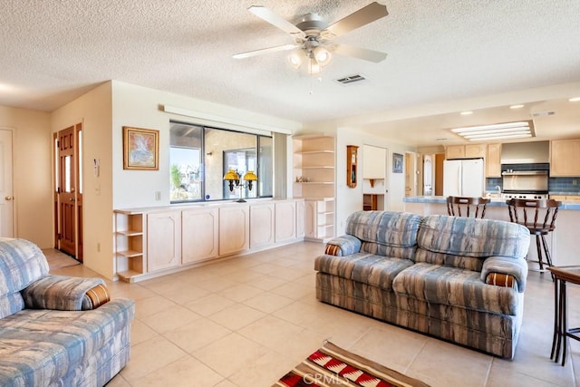 6425 Indian Cove Rd Unit 29, Palms, CA 92277 - living room featuring light tile patterned flooring, a textured ceiling, and a ceiling fan