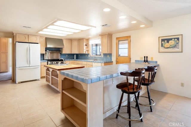 6425 Indian Cove Rd Unit 29, Palms, CA 92277 - kitchen with white appliances, open shelves, light brown cabinets, wall chimney range hood, and recessed lighting
