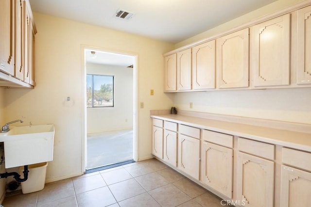 6425 Indian Cove Rd Unit 29, Palms, CA 92277 - kitchen with light countertops, light tile patterned flooring, and baseboards