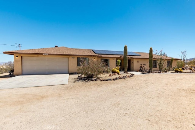 6425 Indian Cove Rd Unit 29, Palms, CA 92277 - ranch-style home featuring concrete driveway, roof mounted solar panels, a garage, and stucco siding