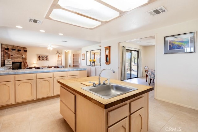 6425 Indian Cove Rd Unit 29, Palms, CA 92277 - kitchen with a sink, light brown cabinets, light tile patterned flooring, open floor plan, and an island with sink
