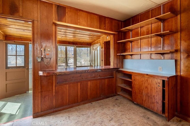 6425 Indian Cove Rd Unit 29, Palms, CA 92277 - kitchen with open shelves, brown cabinets, and wooden walls