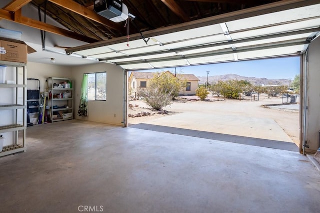 6425 Indian Cove Rd Unit 29, Palms, CA 92277 - garage featuring a garage door opener and a mountain view