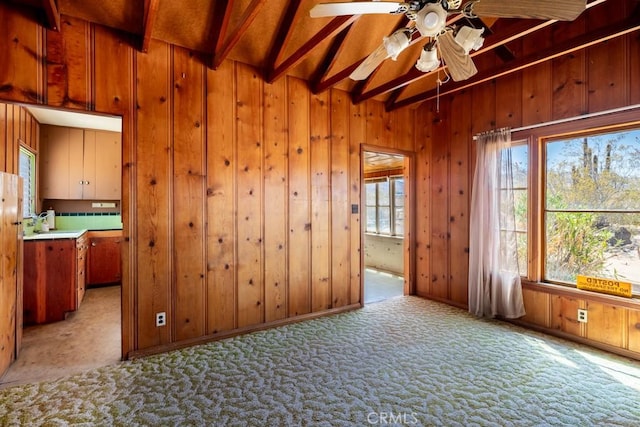 6425 Indian Cove Rd Unit 29, Palms, CA 92277 - unfurnished room with light colored carpet, ceiling fan, beam ceiling, and wooden walls