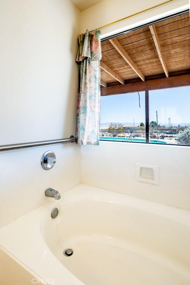 6425 Indian Cove Rd Unit 29, Palms, CA 92277 - bathroom with a bath and wood ceiling with exposed beams