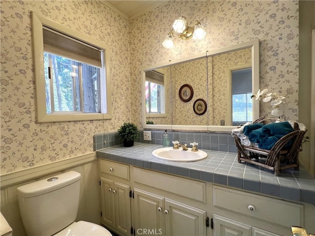 244 Manzanita Dr, Lake Arrowhead, CA 92352 - bathroom featuring wallpapered walls, crown molding, toilet, vanity, and a wainscoted wall