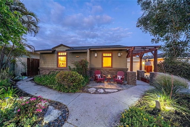 386 Los Altos Ave, Long Beach, CA 90814 - view of front facade featuring a pergola, stone siding, and a patio area