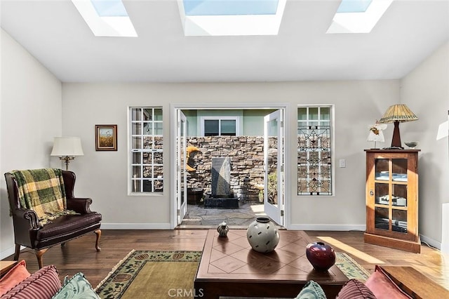 386 Los Altos Ave, Long Beach, CA 90814 - living area with a skylight, wood finished floors, a wood stove, and baseboards