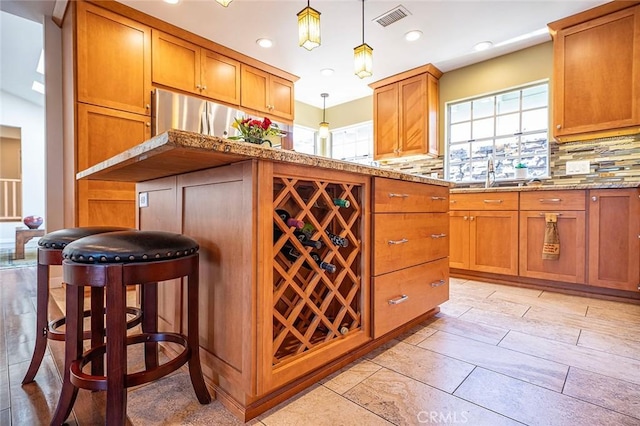 386 Los Altos Ave, Long Beach, CA 90814 - kitchen featuring healthy amount of natural light, brown cabinets, and recessed lighting