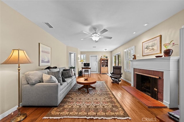 386 Los Altos Ave, Long Beach, CA 90814 - living area with hardwood / wood-style flooring, a brick fireplace, a ceiling fan, and baseboards