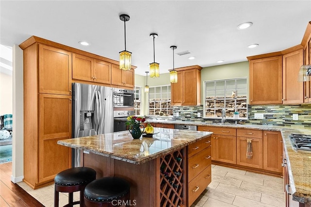 386 Los Altos Ave, Long Beach, CA 90814 - kitchen featuring a sink, appliances with stainless steel finishes, backsplash, light stone countertops, and recessed lighting